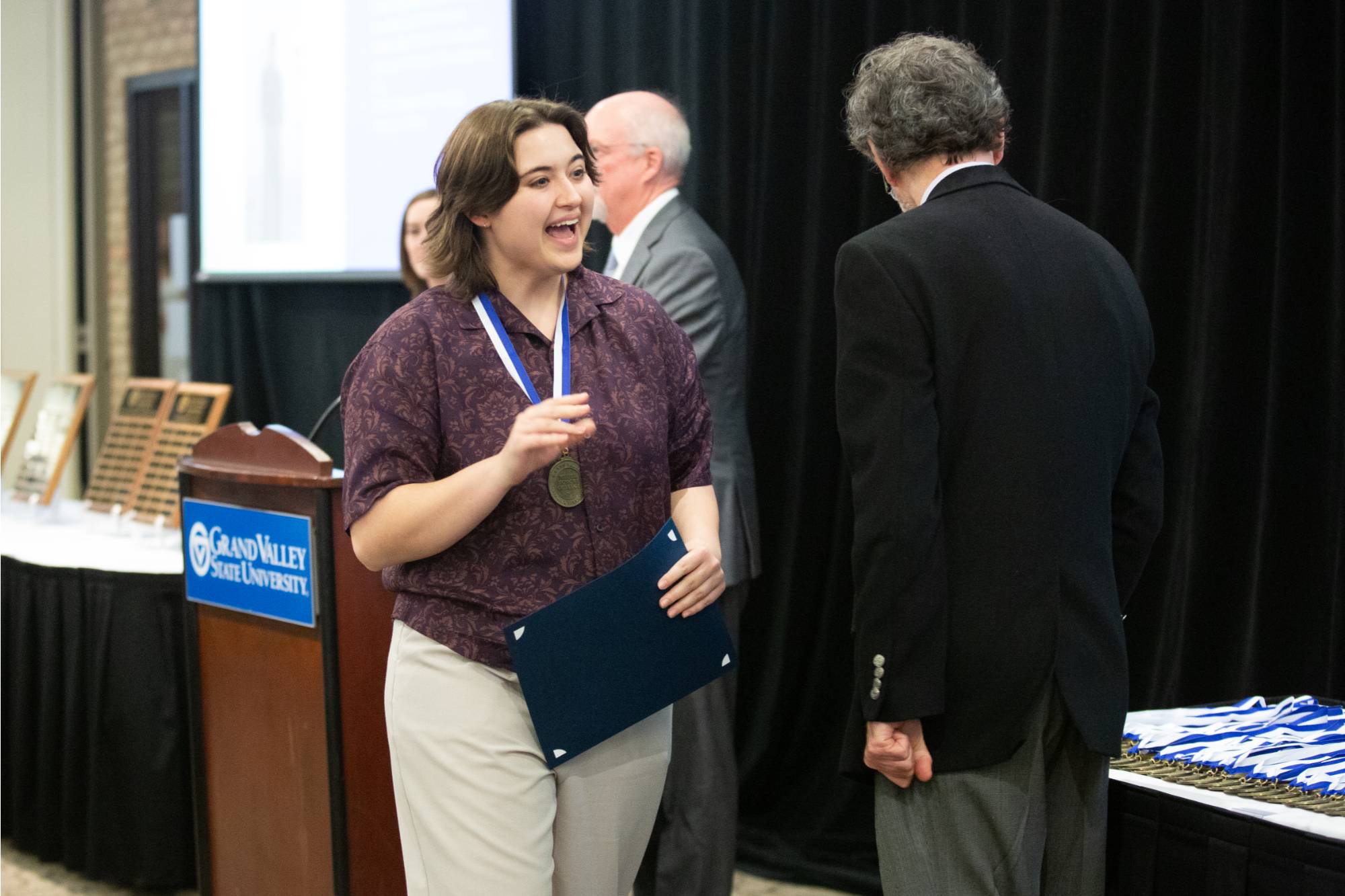 Excited student receives their medallion.